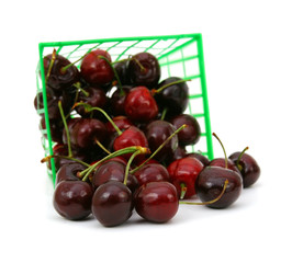 sweet cherries in a basket isolated on white.
