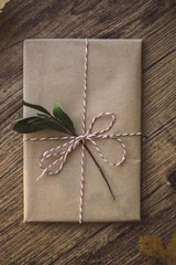 Wrapped gift on a wooden table. 