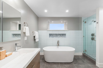 Obraz na płótnie Canvas Luxury bathroom interior with an oval bathtub stone tiles and with glass shower