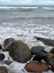 Stones on the beach flooded with waves