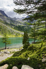 Fototapeta na wymiar Mountain landscape of Arpy lake in a cloudy summer afternoon. Aosta valley, Italian alps.