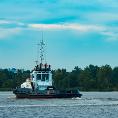 Black tug ship underway