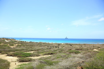 Natural beauty of Aruba. North coast. Off-road Aruba. Amazing stone desert landscape, blue sea and blue sky. September, 2017