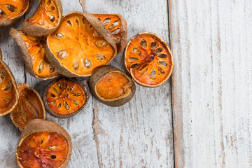 Fototapeta na wymiar Dry Bael fruit - Slices of dry Bael fruit on the wooden table