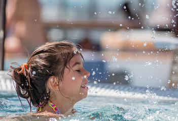 7 year old girl enjoys the pool on a cruise in the Carribean