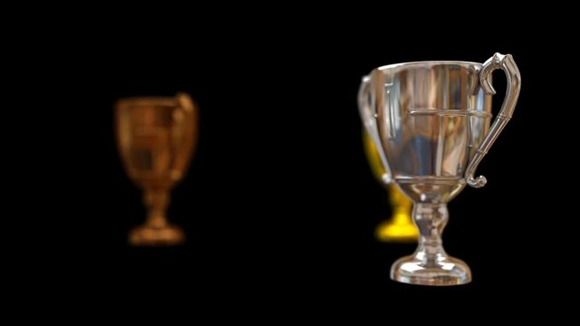 Animating rotating in circle bronze, silver and gold trophy while each is spinning around own axis. With shinning finish surface, and shadow depth of field. Black background, mask included.