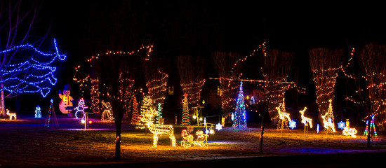 A Christmas light display in the front yard of a home on the drive of lights tour.