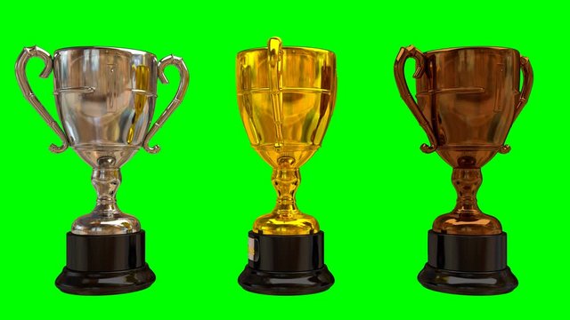 Animated shinning gold, silver and bronze trophy spinning against green background. Dark brown and round reflective stand, and silver plate with text