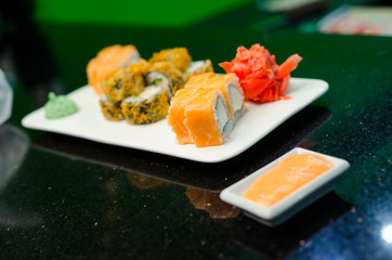 Philadelphia roll classic dark stone on the Board. Salmon, Philadelphia cheese, cucumber, avocado.