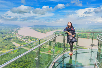 Fototapeta na wymiar Soft focus the lady stand at Thai skywalk, the beautiful sky and cloud at Mekong river, international border between Sangkhom district, Nong Khai Province, Thailand and Laos PDR.