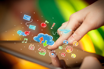 Fingers touching tablet with social icons