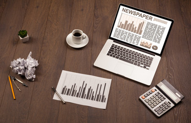 Fototapeta na wymiar Business laptop with stock market report on wooden desk
