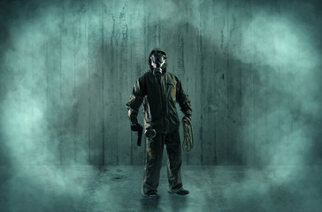 Dreadful man with mask in a wood shanty