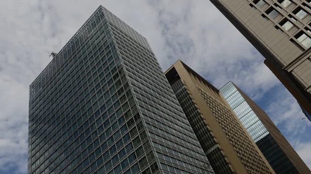 Timelapse HD video of clouds moving over tall skyscraper in city illustrating movement and forward thinking, future and potential modern business concepts