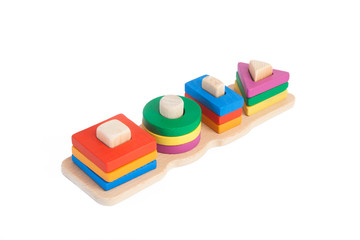 Photo of a wooden toy  children's sorter with small wooden details in the form of geometric shapes (rectangle, square, circle, triangle), in different colors  on a white isolated background