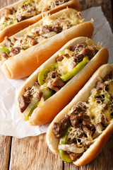 Delicious cheesesteak sandwiches close-up on the table. vertical
