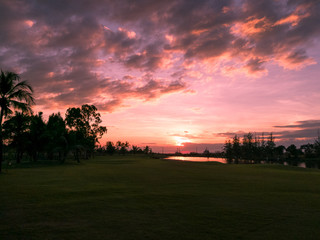 golf course during sunset with water reflection