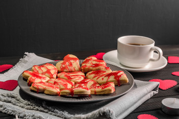 cookie-hearts, paper hearts, candles, boxes with presents and a Cup of black coffee, congratulation with Valentine's day.