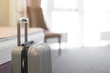 Suitcase or luggage bag in a modern hotel room - obrazy, fototapety, plakaty