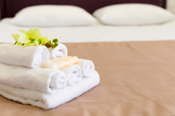 Stack of towels with flower decor in a hotel room