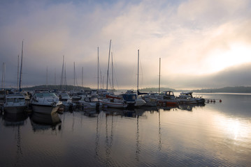 Fototapeta na wymiar Foggy June morning on the Saimaa lake. Lappeenranta, Finland