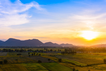 Fototapeta na wymiar Sunset with mountain view background at countryside in Kanchanaburi province, Thailand.