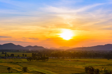 Naklejka na ściany i meble Sunset with mountain view background at countryside in Kanchanaburi province, Thailand.