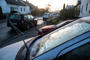 Fototapeta na wymiar Scraping windscreen during winter