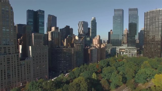 Aerial real time shot, camera is flying above Central Park along West 95th Street in New York City