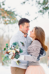 The bride and groom look at each other. Winter wedding.