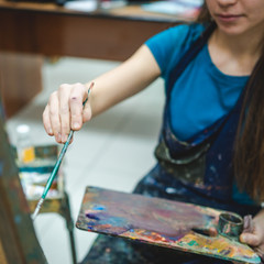 Female painter drawing in art studio