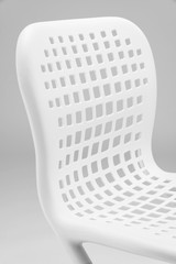 Close-up of a white chair on a light grey background