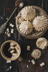 Meringue on a vintage silver plate with coffee and vintage twisted spoon.
