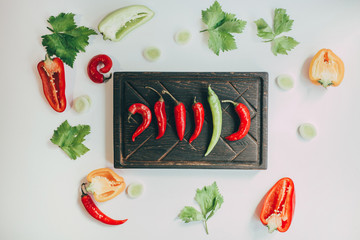 food, healthy eating and nutrition concept - sliced pumpkin and other vegetables on wooden board....