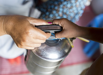 Cambodian woman is sharing the food with a child