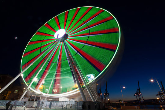 GENOA, ITALY, NOVEMBER 27, 2017 - Ferris wheel with colored lights in "Porto Antico" harbor zone in Genoa, Italy