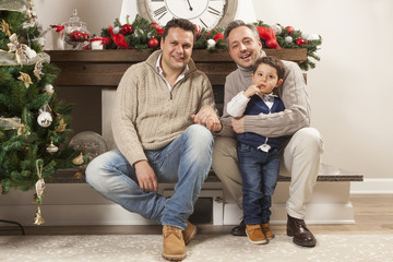 Gay parents pose with their child for Christmas portrait