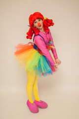 a clowness girl in bright clothes. Create a holiday for children