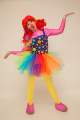 a clowness girl in bright clothes. Create a holiday for children