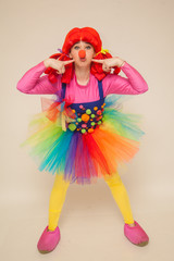 a clowness girl in bright clothes. Create a holiday for children