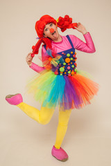 a clowness girl in bright clothes. Create a holiday for children