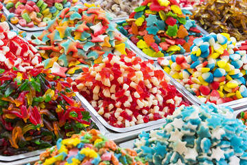 Assortment of jellied colored sweets as a product background