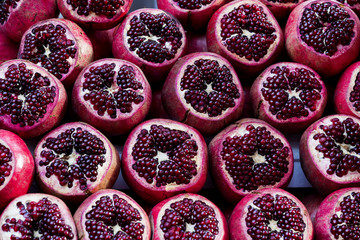 Background of ripe juicy pomegranates shot close-up