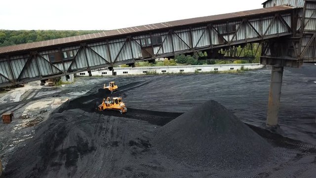 Tracor raking coal