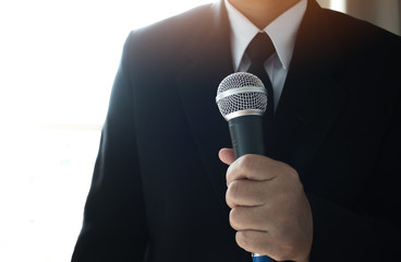 Journalists filing microphone interviewing to businessman. Smart Reporter taking interview and...