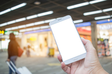 Business right hands using smartphone in class lounge waiting for plane flight. Mock up blank screen white template for advertising graphic display with blur airport terminal. insert text of customer