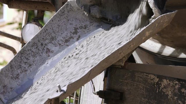 Pouring liquid concrete from mixer