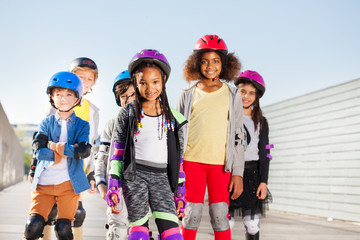 Group of happy sporty kids rollerblading outdoors © Sergey Novikov