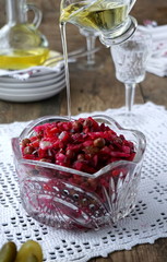 Russian beetroot salad with sauerkraut, carrots, potatoes, green peas, pickled cucumbers and onions