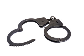 black metal handcuffs with small scratches on white background
